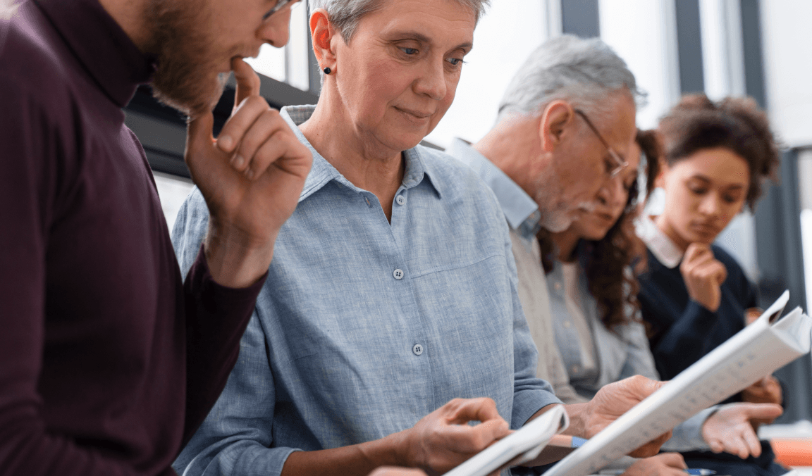 Board members reviewing documents together at a meeting