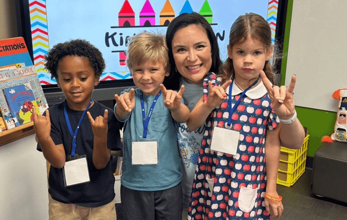 An Alamo Heights teacher with her students in a district classroom