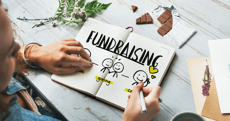 A fundraising plan sketched in a notebook