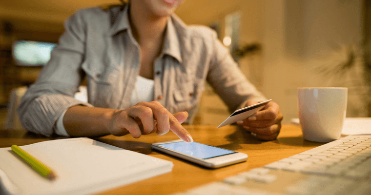 Someone reviewing bank account paperwork at a table
