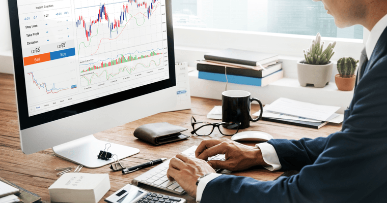 An investment account performance chart on a desktop monitor