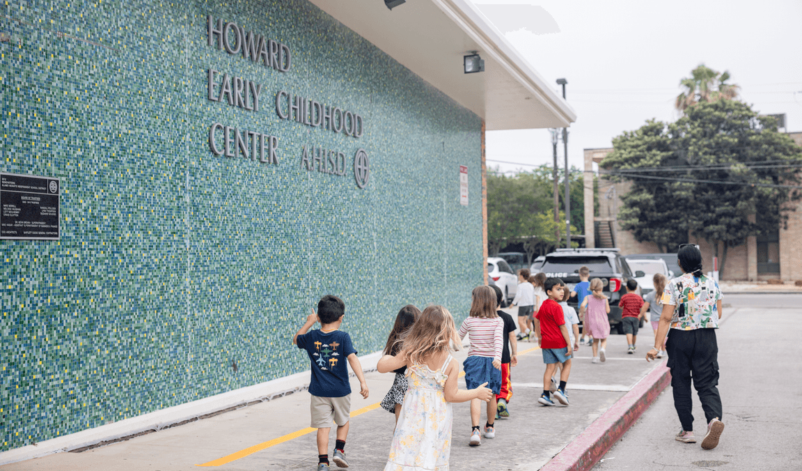 Students walking past the Alamo Heights campus mural